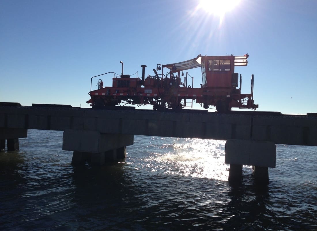 Blacksburg, VA - Large Industrial Machine on a Concrete Bridge Over Water at Sunrise